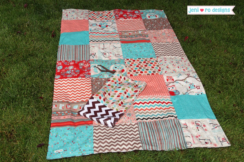 A picnic blanket on ground with bag