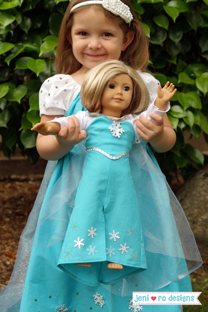 a holding ag doll in elsa dress