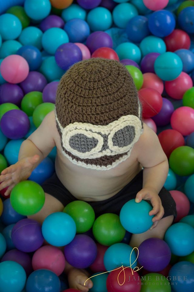 T in ball pit with hat